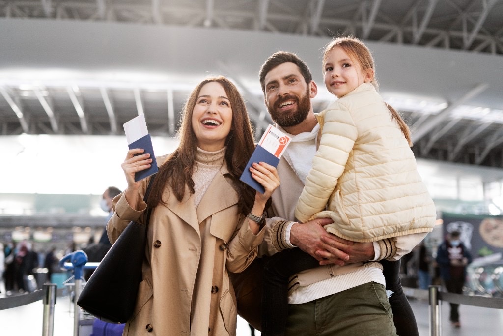 Happy family traveling through an airport terminal