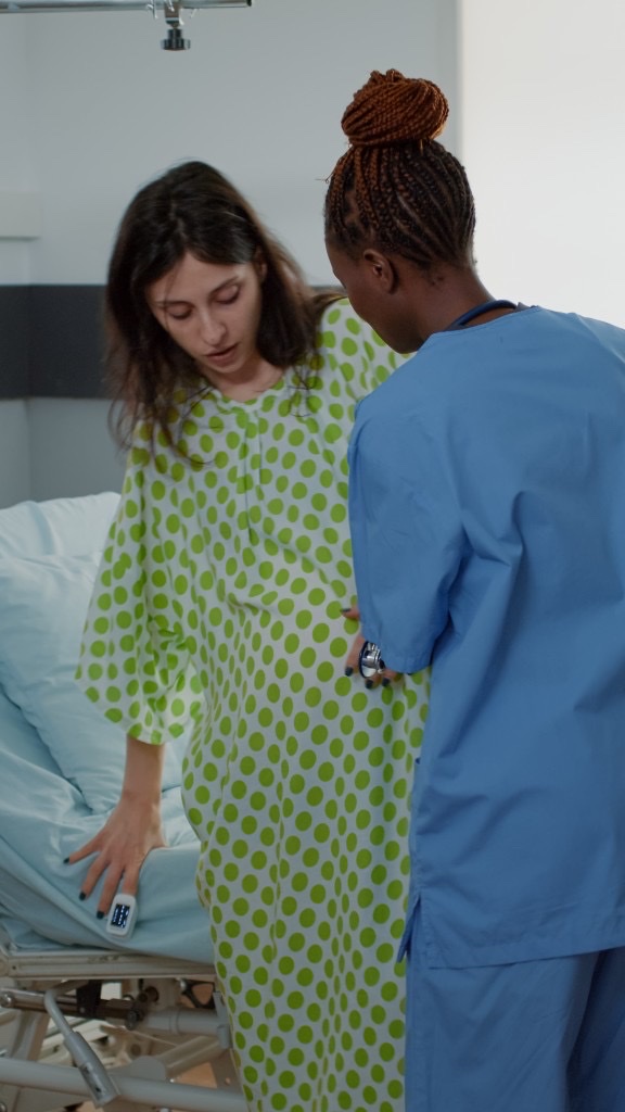 Maternity nurse supporting a mother in hospital