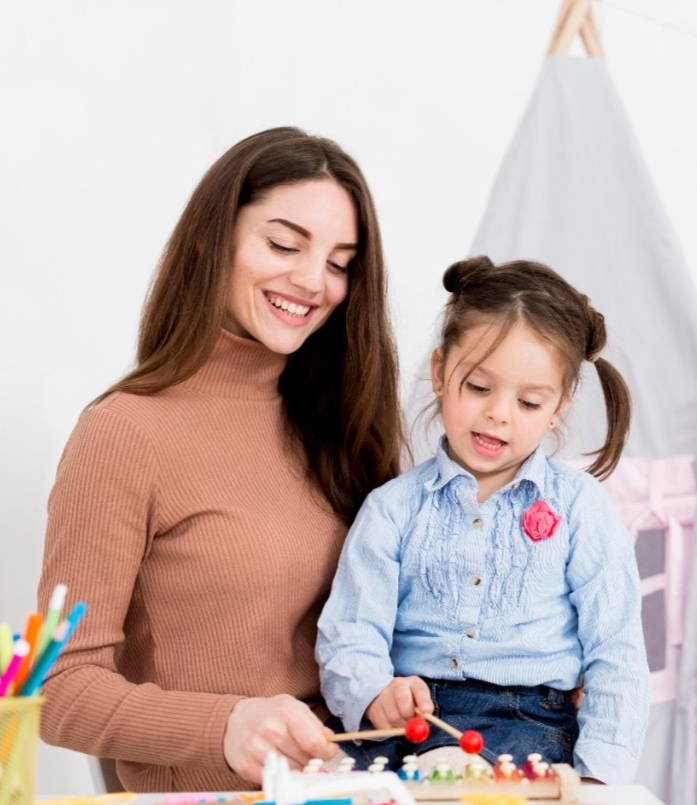 Nanny and child playing together at home