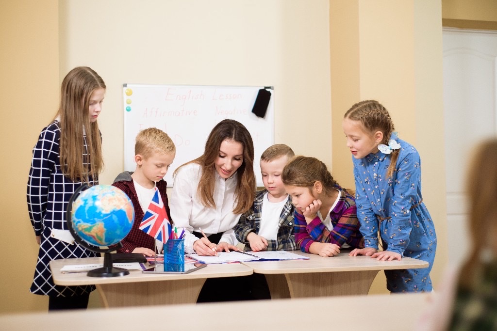 International teacher working with children in the classroom